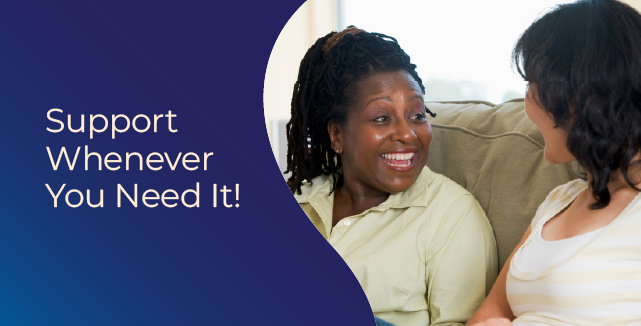 Two women talking and smiling together on a couch. Support whenever you need it!